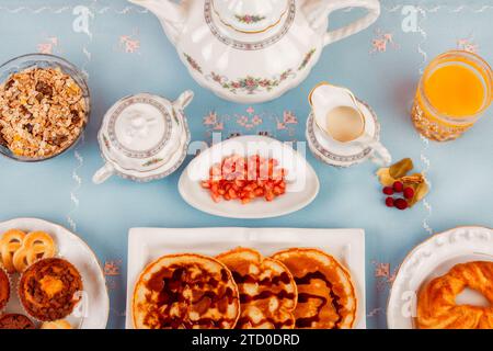An inviting breakfast setup featuring waffles with toppings and a variety of morning treats. Stock Photo