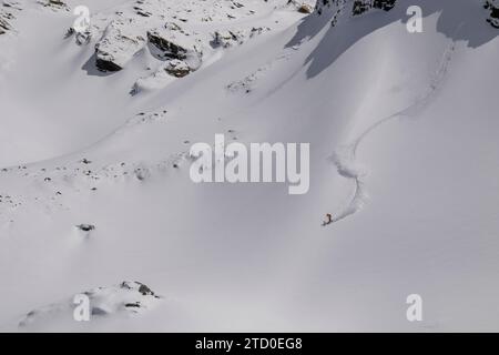 Aerial view of unrecognizable person snowboarding on snow covered mountain slope in Zermatt, Switzerland Stock Photo