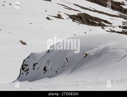 Aerial view of anonymous tourist snowboarding on majestic snow covered mountain slope during vacation in Zermatt, Switzerland Stock Photo