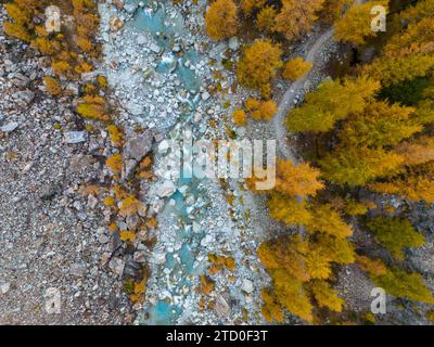 Aerial view of a winding river with clear blue water flowing through a ...