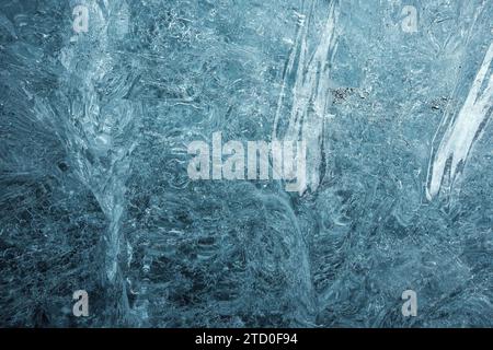 A close-up view showcasing the detailed patterns of frost and ice crystals that have formed on a surface, conveying the beauty and complexity of natur Stock Photo