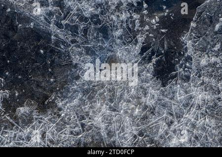 Close-up view of a frozen surface revealing the intricate details and patterns of ice crystals forming a natural abstract background. Stock Photo