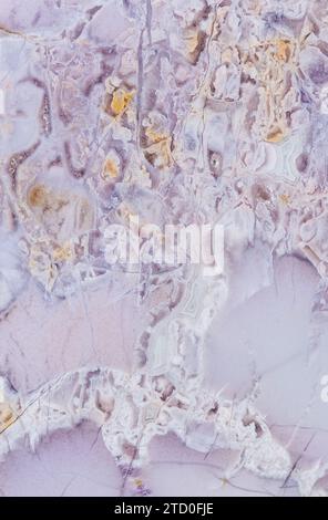 A high-resolution photo capturing the intricate details of natural marble with a mix of subtle purple hues and white veining Stock Photo