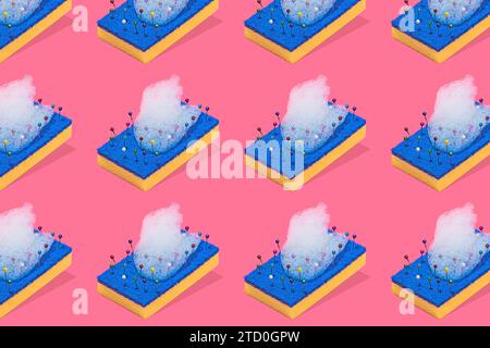A creative representation of a blue and yellow scouring pads with colorful pins and bubbles of foam against a pink background Stock Photo