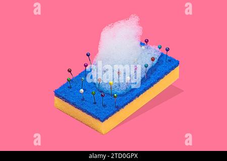A creative representation of a blue and yellow scouring pad with colorful pins and bubbles of foam against a pink background Stock Photo