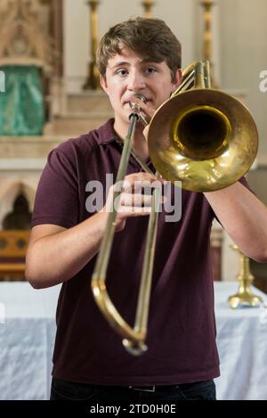 Students in a classroom learning how to play musical instruments Stock Photo