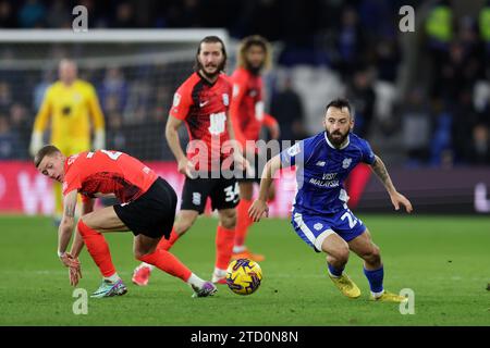 Manolis Siopis of Cardiff City (r) breaks away from Jay Stansfield  of Birmingham City (28). EFL Skybet championship match, Cardiff city v Birmingham City at the Cardiff City Stadium in Cardiff ,Wales on Wednesday 13th December 2023. this image may only be used for Editorial purposes. Editorial use only, pic by  Andrew Orchard/Andrew Orchard sports photography/Alamy Live news Stock Photo