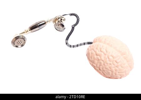 Vintage telephone receiver with human brain anatomical model isolated on white background Stock Photo
