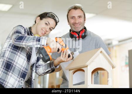 teacher explaining structure to a student in a woodwork class Stock Photo