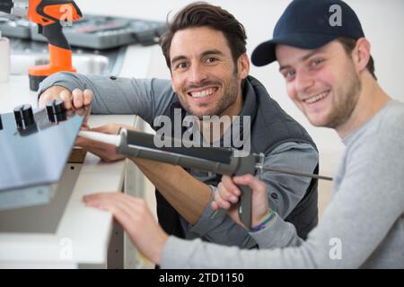 man using a silicone tube with apprentice Stock Photo