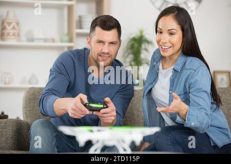 happy couple using modern drone Stock Photo
