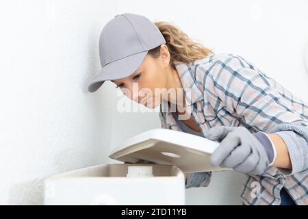 young woman checking and cleaning air conditioning Stock Photo