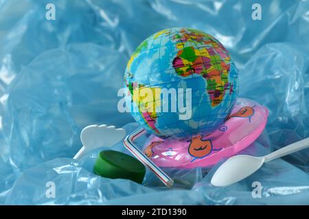 Earth planet in a plastic bottle floating on water - Concept of ecology and stop plastic pollution Stock Photo