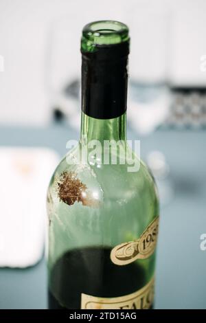 Sediment in wine is either tartrate crystals, wine diamonds, or spent yeast, called lees. Vintage Wine Bottle with Aged Label. Warsaw, Poland - May 02 Stock Photo
