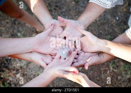 group of people joining hands in the nature Stock Photo