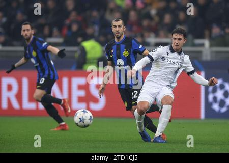 Milan, Italy, 12th December 2023. Martin Zubimendi of Real Sociedad passes the ball as Henrikh Mkhitaryan of FC Internazionale closes in  during the UEFA Champions League match at Giuseppe Meazza, Milan. Picture credit should read: Jonathan Moscrop / Sportimage Stock Photo