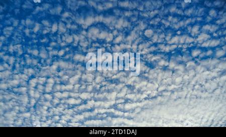 Photo of some white whispy clouds and blue sky cloudscape. The summer sky with its blue color fluffy white clouds. Amazing cloudscape on the sky at da Stock Photo