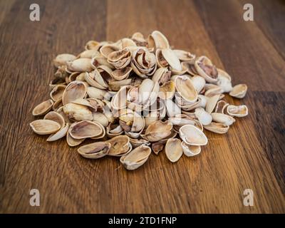 Large pile of empty pistachio shells eaten pistachios remains Stock Photo
