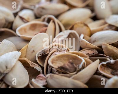 Large pile of empty pistachio shells eaten pistachios remains Stock Photo