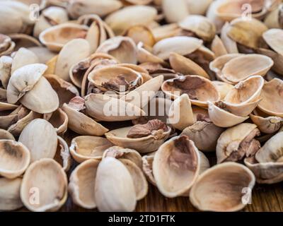 Large pile of empty pistachio shells eaten pistachios remains Stock Photo