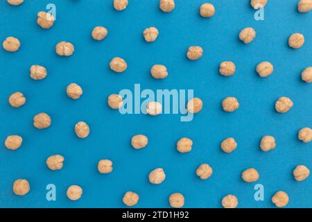 creative food layout, hazelnuts on blue background, top view, concept of food, healthy nutrition, hazelnut flat lay, nut pattern, organic healthy vega Stock Photo
