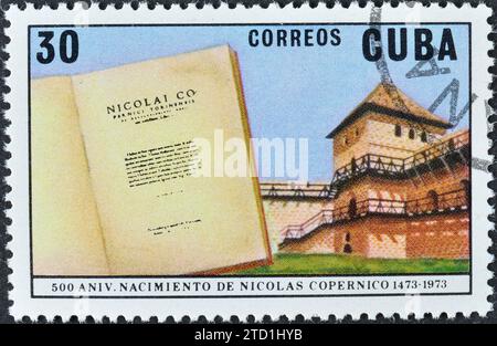 Cancelled postage stamp printed by Cuba, that shows 'De Revolutionibus Orbium Celestium' and Frombork Tower, 500th Birth Anniversary of Copernicus Stock Photo