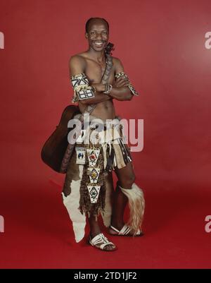 Traditional South African Musician in Splendid Traditional Outfit, Ngicela Ukubza, 1985, Yeoville, Johannesburg Gauteng, South Africa. From the collection - South African Musicians 1980s - Don Minnaar photographic archive Stock Photo