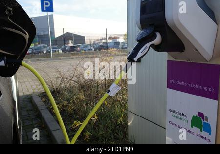 Neuenhaus, Germany- Nov 17 2023 Grafshafter carsharing. All electric car sharing car connected to a charging station. Stock Photo
