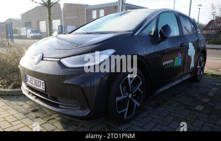 Neuenhaus, Germany- Nov 17 2023 Grafschafter carsharing. All electric car sharing car connected to a charging station. It's a black Volkswagen ID3 Stock Photo