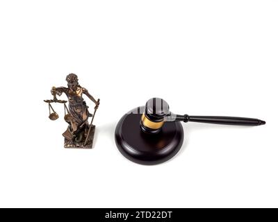 Bronze statue of Lady Justice and a judge's gavel on a white background. Statue of justice and judge's gavel close-up. Stock Photo