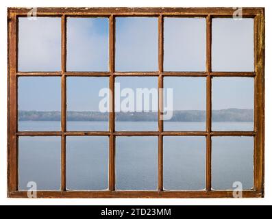 foggy morning over a lake or wide river as seen from a retro sash window Stock Photo