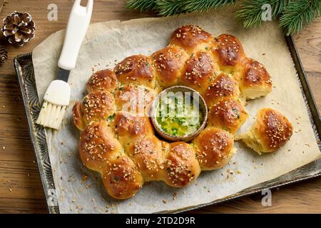 freshly baked christmas bread with melted butter with garlic and parsley on baking try Stock Photo
