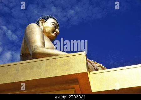 The golden Buddha Dordenma statue silhouetted against blue sky in the Kuensel Phodrang nature park overlooking the entrance to Thimphu Valley, Bhutan. Stock Photo