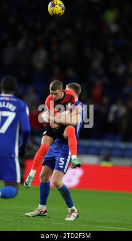 Mark McGuinness of Cardiff City (r) &Jay Stansfield of Birmingham City (28) in action. EFL Skybet championship match, Cardiff city v Birmingham City at the Cardiff City Stadium in Cardiff ,Wales on Wednesday 13th December 2023. this image may only be used for Editorial purposes. Editorial use only, pic by  Andrew Orchard/Andrew Orchard sports photography/Alamy Live news Stock Photo