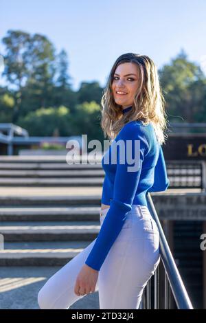 Beautiful Young Happy Woman Wearing Bright Colors on Steps in Front of City Hall Los Gatos Sunny Afternoon Stock Photo