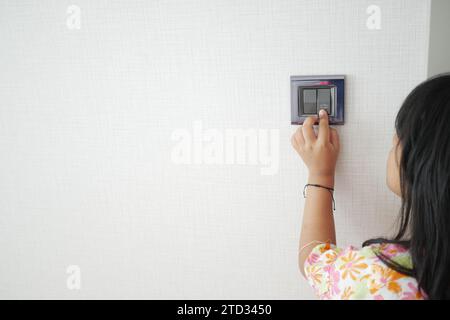 child finger turning on lighting switch with copyspace  Stock Photo