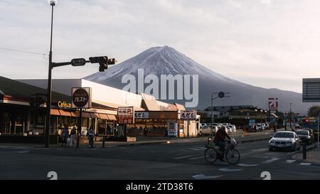 Beautiful scenery of Mount Fuji in the background and shops in front. Captured while walking through the streets of Fuji slightly before sunset. Stock Photo