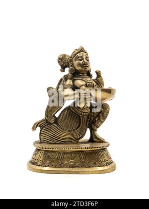 a souvenir gold statue of a goddess holding and offering a bowl of holy water which gives divine power isolated in a white background Stock Photo