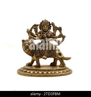 statue of goddess durga devi of hindu religion holding multiple weapons in her many arms, sitting on her lion Stock Photo