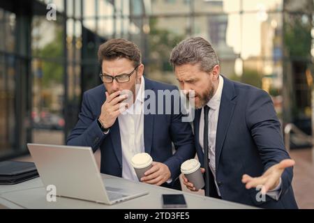 photo of amazed trader men freelancing online. two trader men freelancing online. Stock Photo