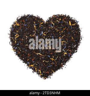 Black tea with dried flower leaves in heart shape isolated on white background Stock Photo