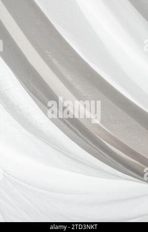 white fabric curtain creases back lit, soft focus close up Stock Photo