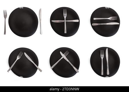 Cutlery gestures on six black ceramic plates, message for the chef about meal quality Stock Photo