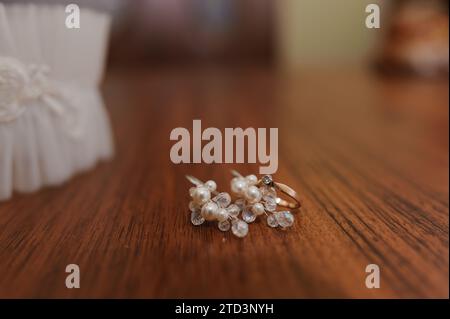 Diamond ring on a brown background. Earrings and ring on a background Stock Photo