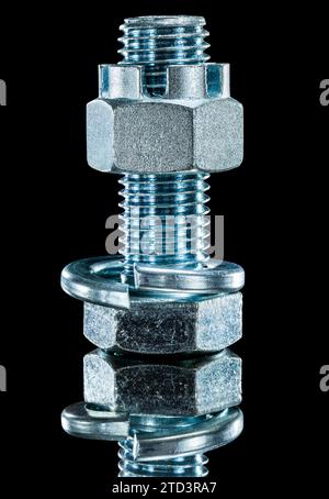 Construction nut screwbolt spring washer on black surface Stock Photo