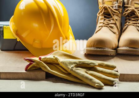 Yellow leather gloves working boots construction helmet toolbox Stock Photo