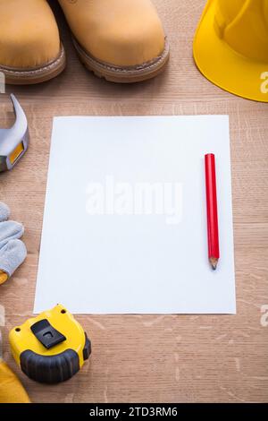 Blank sheet of paper with pencil and construction tools on wooden board Stock Photo