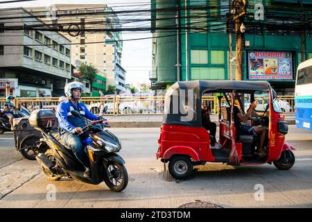 A tuk tuk or trike makes its way through the busy, tight streets of Manila, The Philippines. Stock Photo