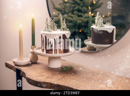Christmas dessert table. Icing cake decorated with pin tree twig Stock Photo