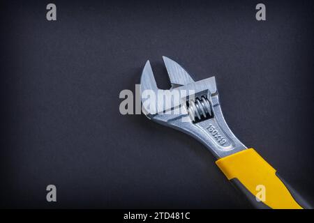 Adjustable spanner in close-up on a black background Stock Photo